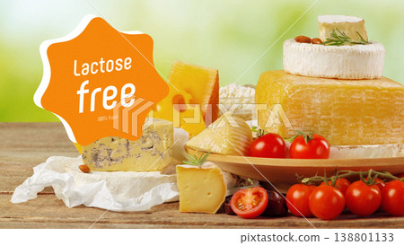Fresh lactose gluten free cheeses arranged on a wooden table with tomatoes and herbs 138801133