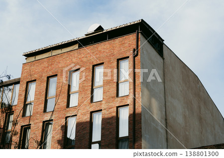 Building with a roof structure and multiple windows under a blue sky in the daytime Building with a roof structure and multiple windows under a blue sky in the daytime 138801300