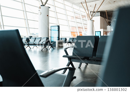 Seats in an empty airport terminal during daytime waiting for passengers Seats in an empty airport terminal during daytime waiting for passengers 138801302