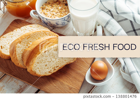 Fresh bread with milk, egg, and snacks on a table at a kitchen during day time Fresh bread with milk, egg, and snacks on a table at a kitchen during day time 138801476