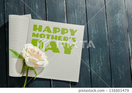 Celebrating Mother's Day on May 10 with a note and a flower on a wooden table Celebrating Mother's Day on May 10 with a note and a flower on a wooden table 138801479