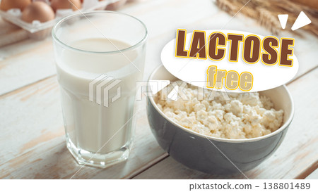 Enjoying lactose-free milk and cheese on a wooden table at a cozy kitchen Enjoying lactose-free milk and cheese on a wooden table at a cozy kitchen 138801489