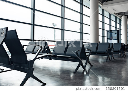 Waiting area with empty seats at an airport in daylight hours Waiting area with empty seats at an airport in daylight hours 138801501