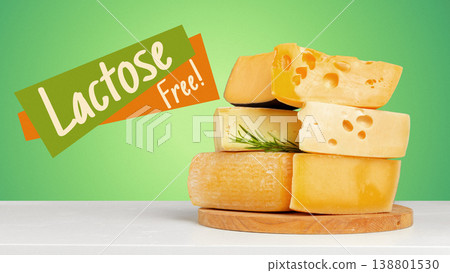 Lactose free cheese displayed on a wooden board with green background 138801530