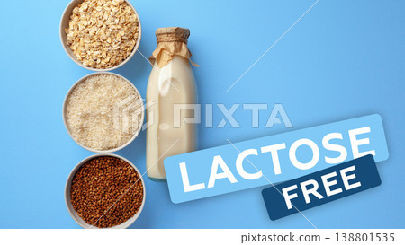 Lactose and gluten free ingredients in bowls and a bottle on a blue background Lactose and gluten free ingredients in bowls and a bottle on a blue background 138801535
