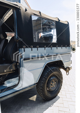 Silver car parked beside a building with black soft top during daytime Silver car parked beside a building with black soft top during daytime 138801577