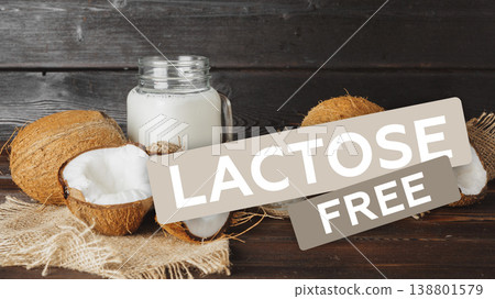 Lactose free coconut milk beside fresh whole coconuts on wooden table Lactose free coconut milk beside fresh whole coconuts on wooden table 138801579