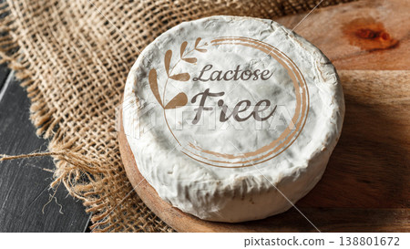 Cheese product labeled lactose gluten free on wooden surface in kitchen setting Cheese product labeled lactose gluten free on wooden surface in kitchen setting 138801672