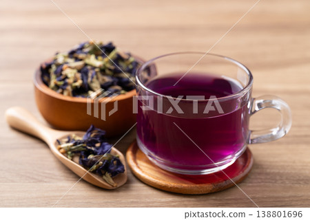 Hot butterfly pea tea in glass cup with dried flowers on wooden background, Healthy herbal drink 138801696