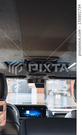 Interior view of a vehicle showing dashboard and gauges during daylight Interior view of a vehicle showing dashboard and gauges during daylight 138801734