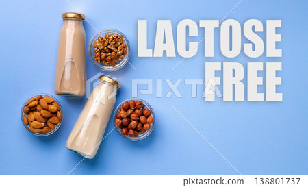Milk alternatives with nuts on blue surface for lactose gluten free diet Milk alternatives with nuts on blue surface for lactose gluten free diet 138801737