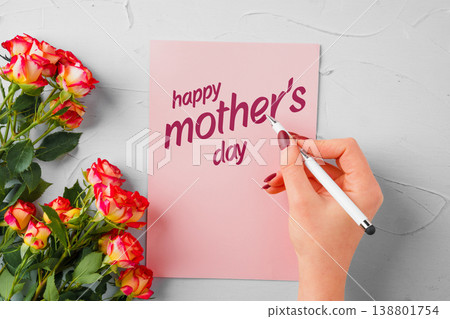 Writing a happy mother's day card with pink roses on a light background Writing a happy mother's day card with pink roses on a light background 138801754