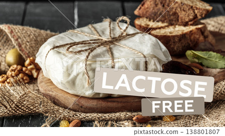Lactose free cheese on a wooden board with bread and nuts during a casual dining moment Lactose free cheese on a wooden board with bread and nuts during a casual dining moment 138801807