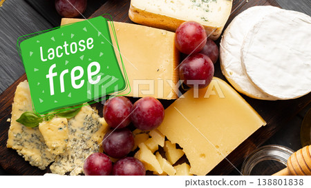 Cheese and grapes arrangement with lactose free sign on wooden board during a snack time Cheese and grapes arrangement with lactose free sign on wooden board during a snack time 138801838