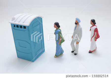 Miniature Figures Queuing At Portable Toilet 138802514