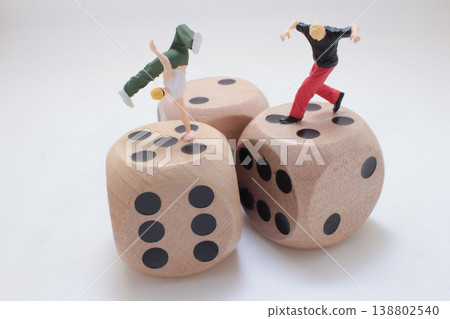 Miniature Figures Balancing On Wooden Dice 138802540