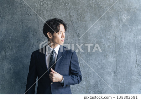 Portrait of a young male businessperson in a suit Portrait of a young male businessperson in a suit 138802581