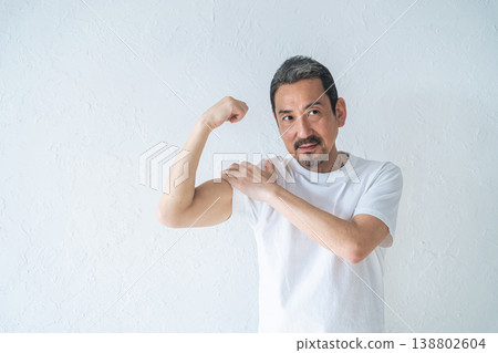 A middle-aged man showing off his biceps A middle-aged man showing off his biceps 138802604