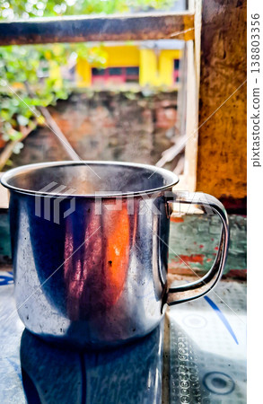 close up image of a cup of hot coffee with smoke coming from the cup close up image of a cup of hot coffee with smoke coming from the cup 138803356