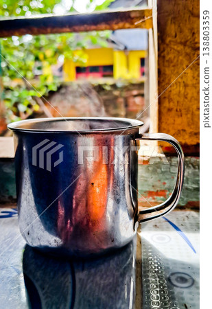 close up image of a cup of hot coffee with smoke coming from the cup 138803359