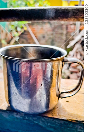 close up image of a cup of hot coffee with smoke coming from the cup close up image of a cup of hot coffee with smoke coming from the cup 138803360