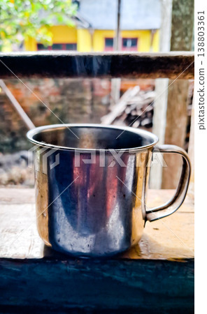 close up image of a cup of hot coffee with smoke coming from the cup close up image of a cup of hot coffee with smoke coming from the cup 138803361