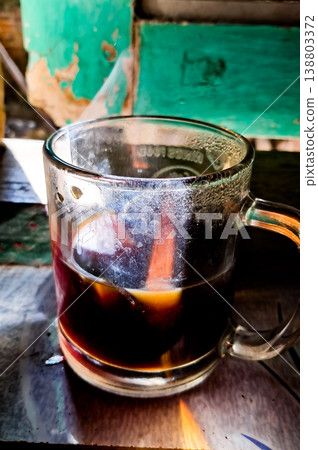 close up image of a cup of hot coffee with smoke coming from the cup 138803372