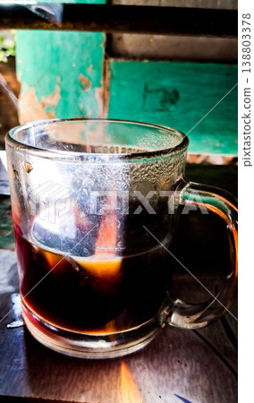close up image of a cup of hot coffee with smoke coming from the cup close up image of a cup of hot coffee with smoke coming from the cup 138803378