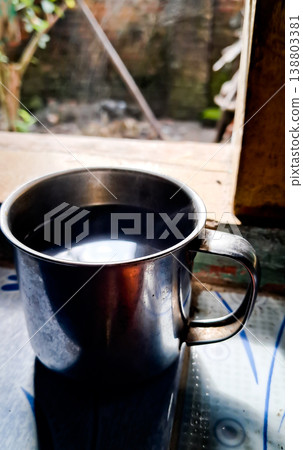 close up image of a cup of hot coffee with smoke coming from the cup close up image of a cup of hot coffee with smoke coming from the cup 138803381