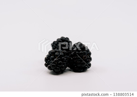 Close-up of three fresh blackberries placed on a white background Close-up of three fresh blackberries placed on a white background 138803514