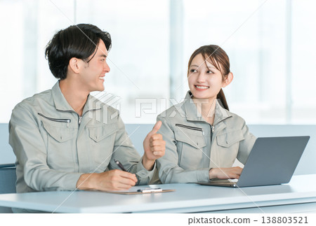 A businessman and his wife in work clothes converse and communicate with their subordinates. A businessman and his wife in work clothes converse and communicate with their subordinates. 138803521