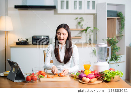 Healthy Asian woman cooking at home, chopping fresh vegetables for clean eating, detox smoothie and meal prep. Nutrition, diet, wellness Healthy Asian woman cooking at home, chopping fresh vegetables for clean eating, detox smoothie and meal prep. Nutrition, diet, wellness 138803681