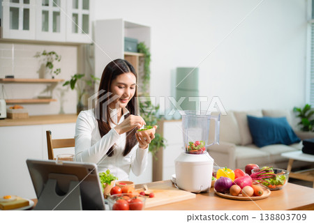 Healthy Asian woman making detox smoothie at home kitchen, adding fresh fruits and vegetables to blender. Clean eating, nutrition diet, wellness lifestyle Healthy Asian woman making detox smoothie at home kitchen, adding fresh fruits and vegetables to blender. Clean eating, nutrition diet, wellness lifestyle 138803709