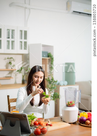 Healthy Asian woman making detox smoothie at home kitchen, adding fresh fruits and vegetables to blender. Clean eating, nutrition diet, wellness lifestyle Healthy Asian woman making detox smoothie at home kitchen, adding fresh fruits and vegetables to blender. Clean eating, nutrition diet, wellness lifestyle 138803710