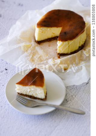 Cheesecake with baking paper on white marble table. 138803808