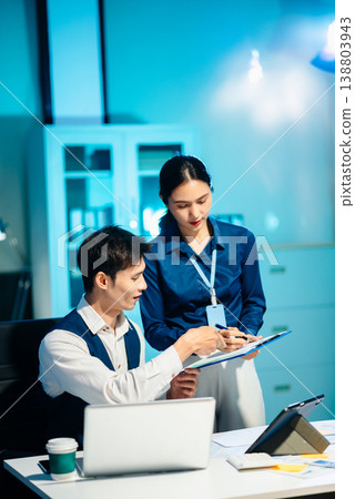 Asian colleagues discussing project plans and reviewing documents in a modern office. Concept of business teamwork, strategy Asian colleagues discussing project plans and reviewing documents in a modern office. Concept of business teamwork, strategy 138803943