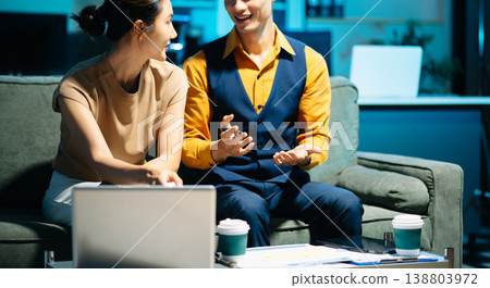 Asian couple working together with a tablet and laptop, discussing ideas with smiles. Concept of teamwork 138803972