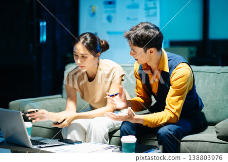 Asian couple working together with a tablet and laptop, discussing ideas with smiles. Concept of teamwork 138803976