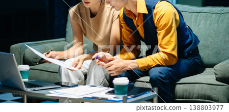 Asian couple working together with a tablet and laptop, discussing ideas with smiles. Concept of teamwork Asian couple working together with a tablet and laptop, discussing ideas with smiles. Concept of teamwork 138803977