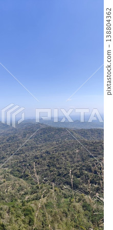 view of the land from the top of the hill with a cloudy blue sky view of the land from the top of the hill with a cloudy blue sky 138804362