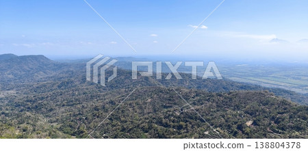 view of the land from the top of the hill with a cloudy blue sky view of the land from the top of the hill with a cloudy blue sky 138804378