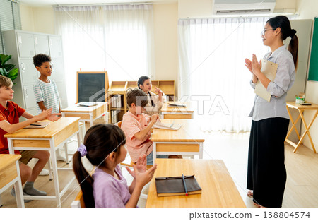 The teacher and students clap their hands to celebrate and congratulate to one that give the correct answer or give highest point in the exam. The teacher and students clap their hands to celebrate and congratulate to one that give the correct answer or give highest point in the exam. 138804574