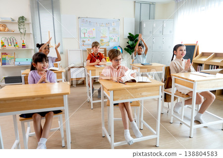 Many child compete to answer the question in classroom by raise their hands and wait the selection from teacher. 138804583