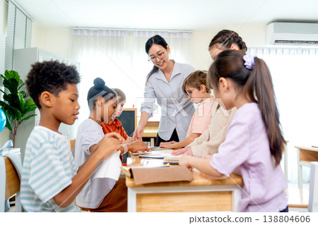 Side view Asian teacher teach and explain the process of fold the paper to be more creation shape such as rocket or animal and kids enjoy with this activity. 138804606