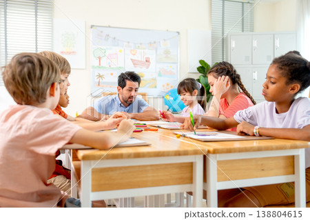 The teacher stay on head of the table and explain about draw and paint classroom before the children witll start to create their working. The teacher stay on head of the table and explain about draw and paint classroom before the children witll start to create their working. 138804615