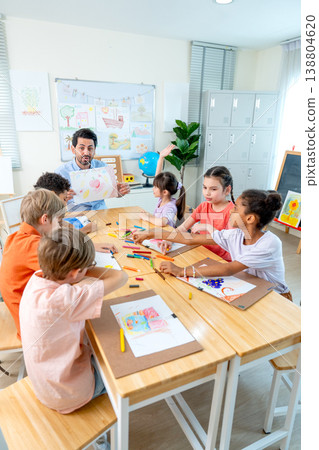 Vertical image of the teacher hold the picture that is the creation from kid in the classroom and give rating also ask for the idea and explaination from the owner. 138804620
