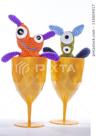 Knitted wool aliens in a glass on a white background 138804917