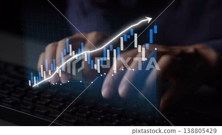 Close-up of Hands Typing on Keyboard with Stock Market Chart Overlay Visualizing Data Growth and Financial Trends in Modern Technology Environment Copula 138805429