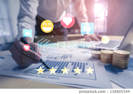 Businessman Analyzing Financial Data with Social Media Icons and Coins on Desk Representing Digital Engagement and Financial Growth in Modern Workplace Ledger Businessman Analyzing Financial Data with Social Media Icons and Coins on Desk Representing Digital Engagement and Financial Growth in Modern Workplace Ledger 138805544