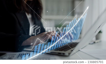 Business Professional Typing on Laptop with Abstract Graph Overlay Representing Growth and Success in Modern Corporate Environment Copula 138805701